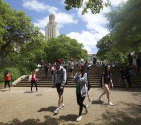 Students walking along the steps in front of the Tower on a sunny day.